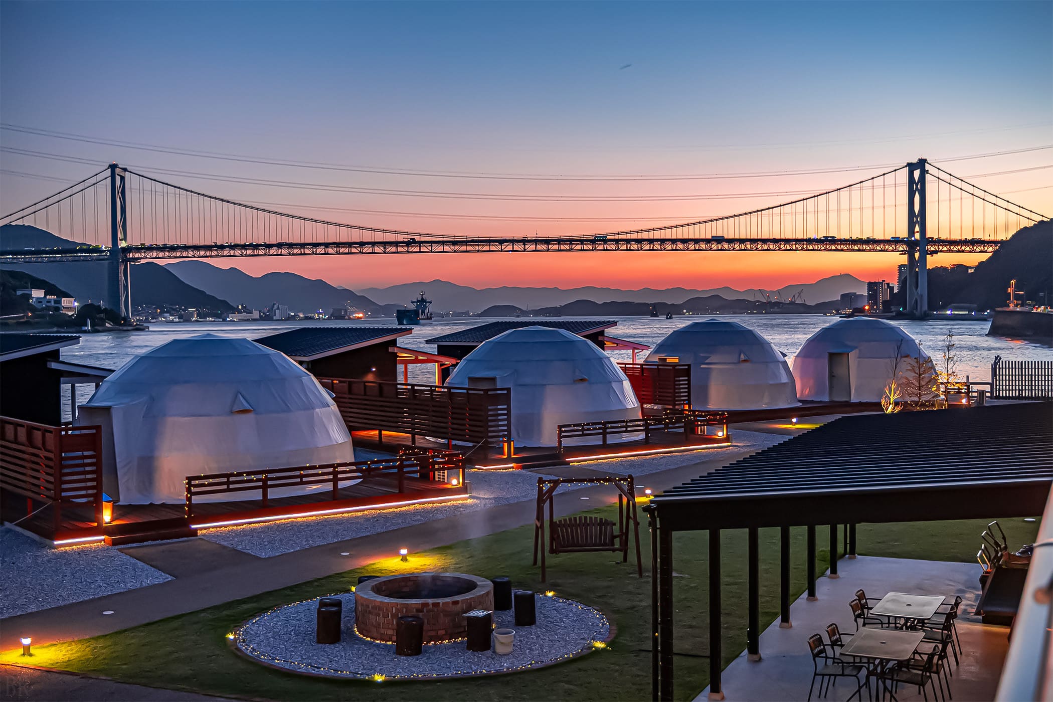 Sunset exterior view of GLAMP DOME SHIMONOSEKI